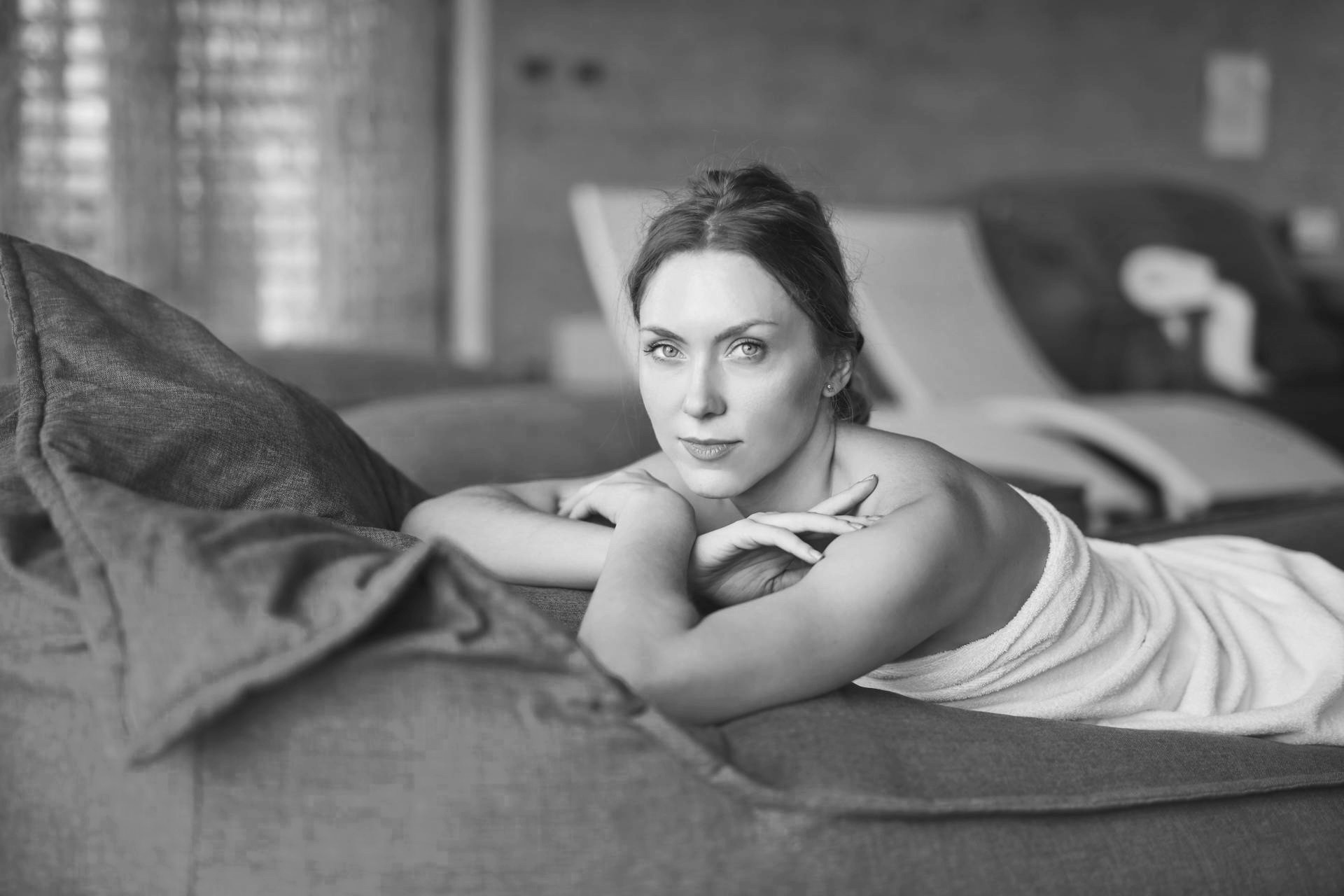 The beautiful lady feels happy during a massage session.